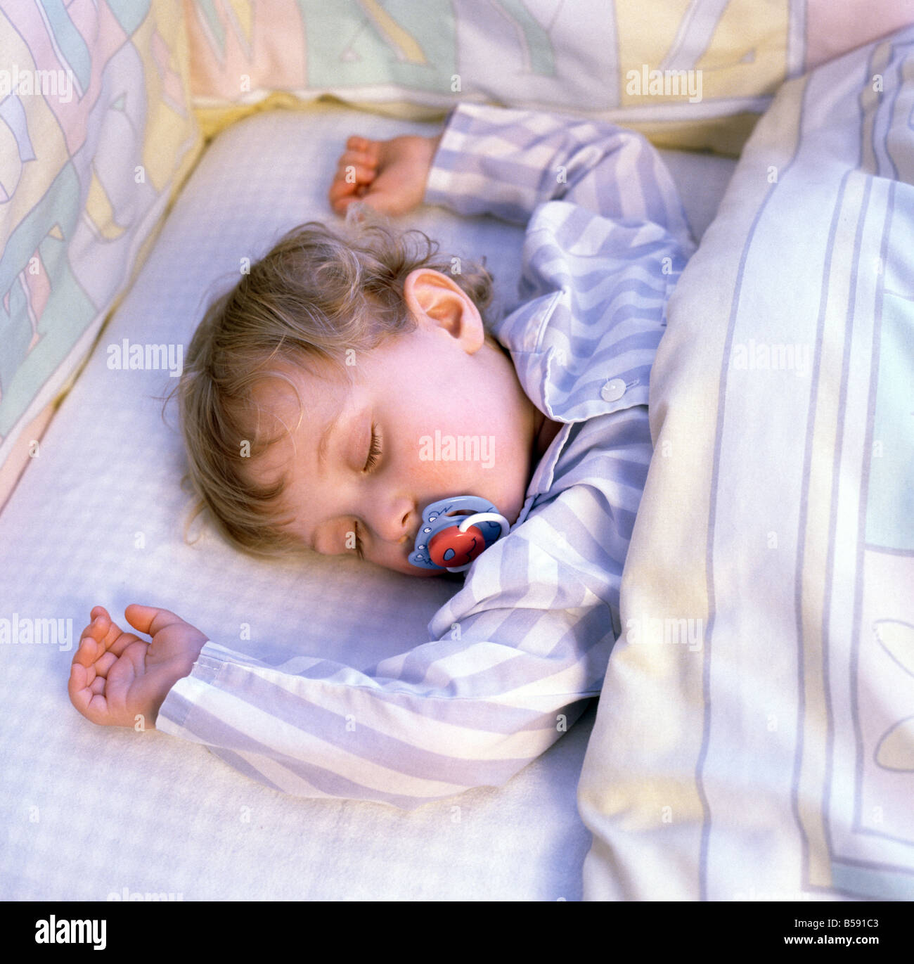 Child 18 months, boy, asleep in cot with dummy Stock Photo Alamy