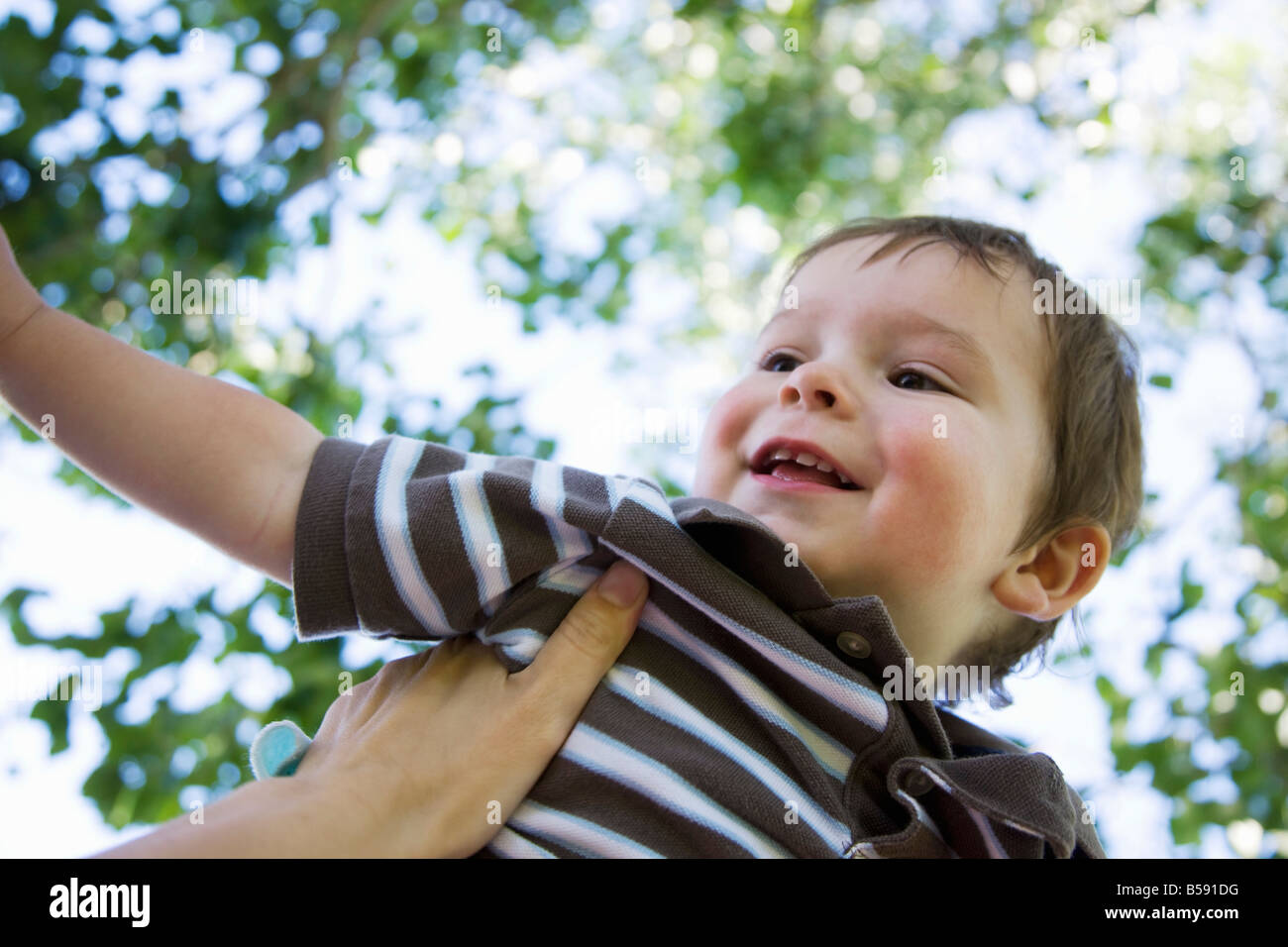 Little boy being lifted up Stock Photo - Alamy