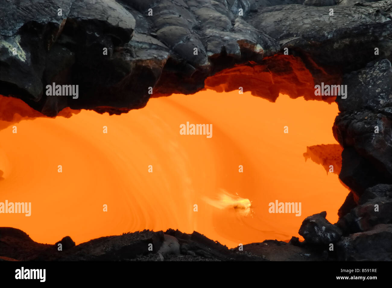 Skylight and flowing lava Waikupanaha ocean entry lava flow Stock Photo