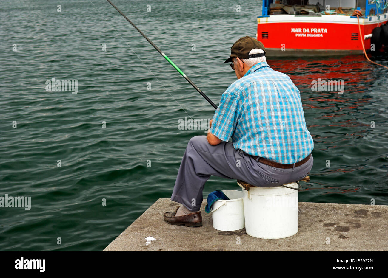A Guy Fishing at a Floating Dock Editorial Stock Photo - Image of