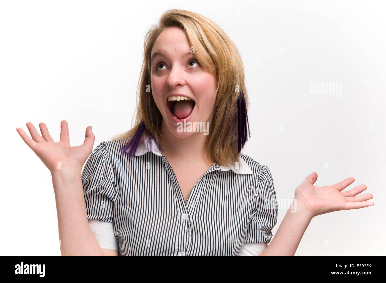 young blonde haired woman looking happy and surprised Stock Photo - Alamy