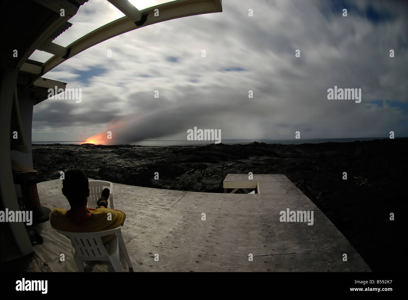 Lava viewing from the last private residense left in the area under the light of the full moon Stock Photo