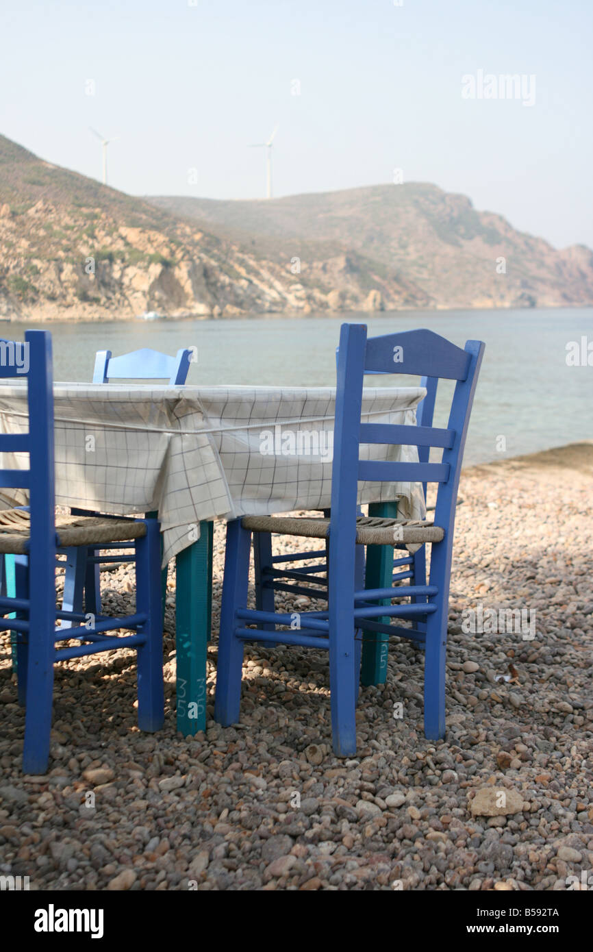 blue chairs by the sea at traditional greek taverna patmos island