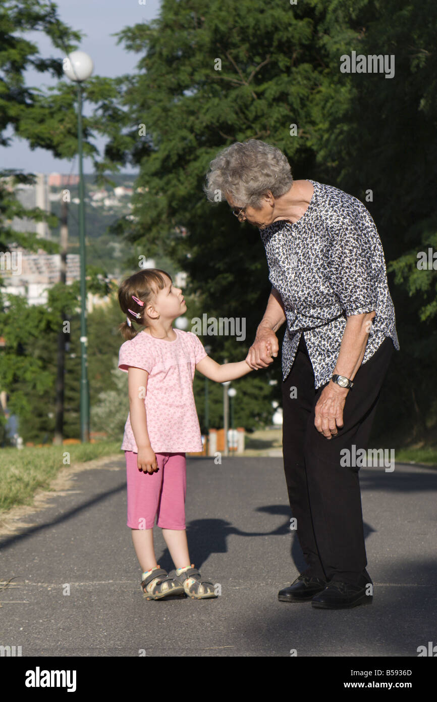 Grandmother and granddaughter by the walk Stock Photo