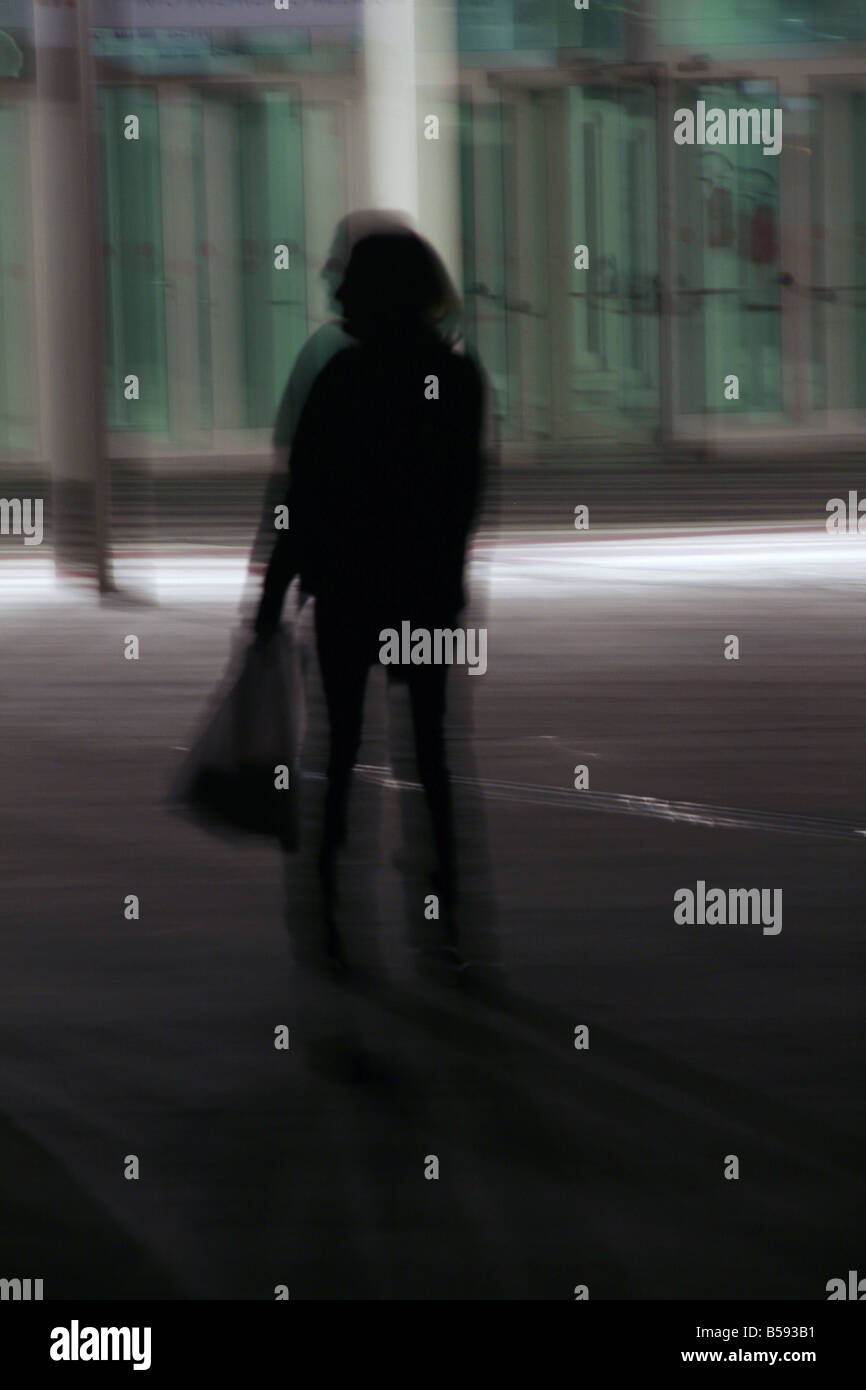 one woman walking in street at night Stock Photo - Alamy