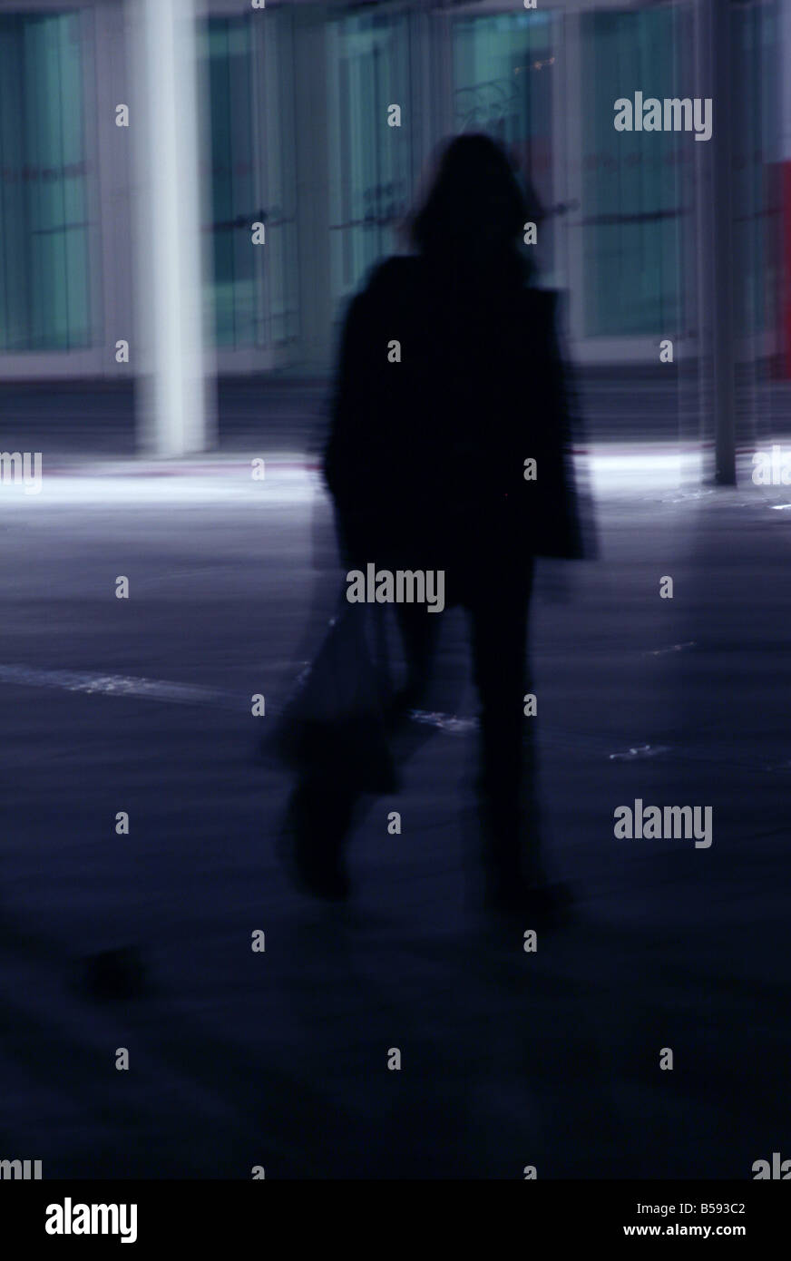 one woman walking in street at night Stock Photo - Alamy