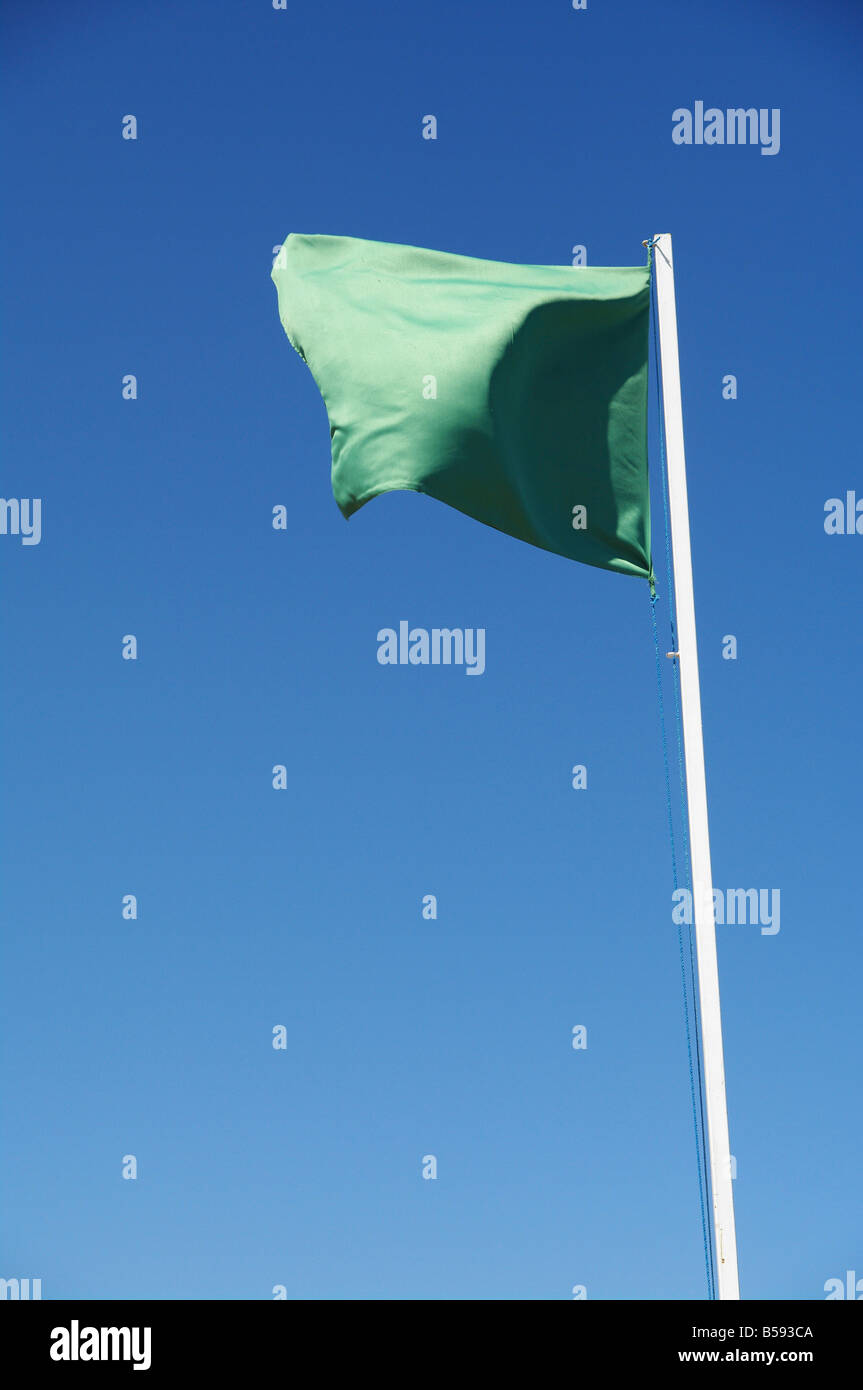 green flag against blue sky Stock Photo Alamy
