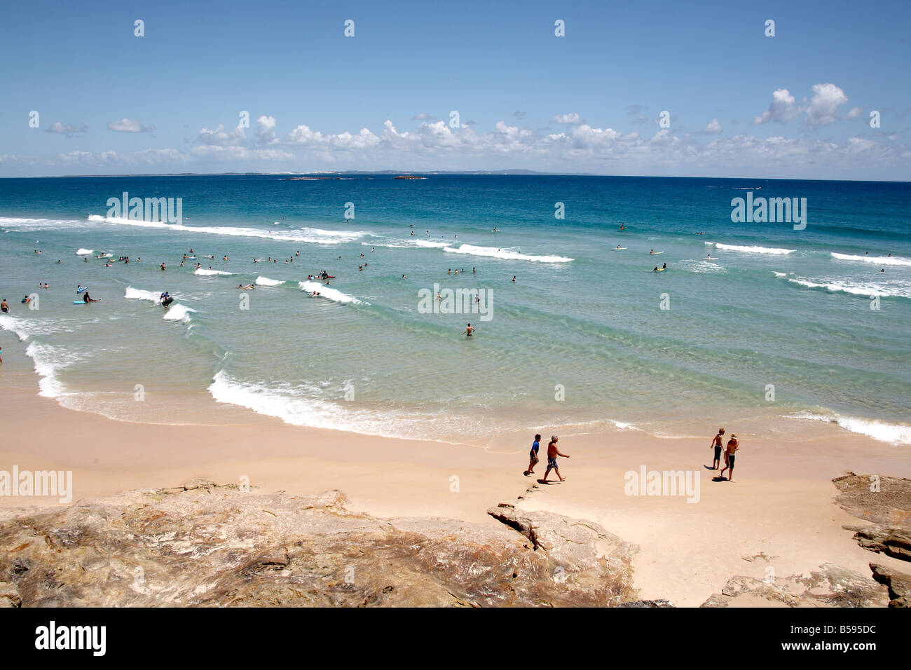 Cylinder beach on a summer day with people swimming in the sea and walking on North Stradbroke Island Queensland QLD Australia Stock Photo