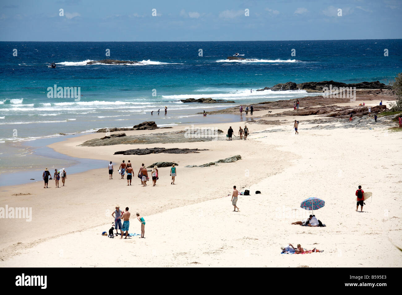 Deadmans beach with people swimming and sunbathing by the sea in summer on North Stradbroke Island Queensland QLD Australia Stock Photo