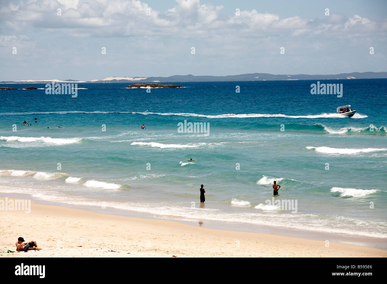Deadmans beach with people swimming and sunbathing by the sea in summer on North Stradbroke Island Queensland QLD Australia Stock Photo