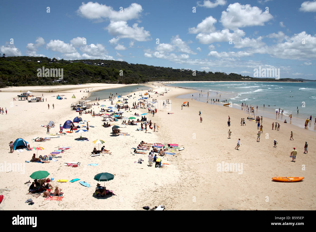 Cylinder beach summer day with people swimming in the sea and sunbathing on North Stradbroke Island Queensland QLD Australia Stock Photo