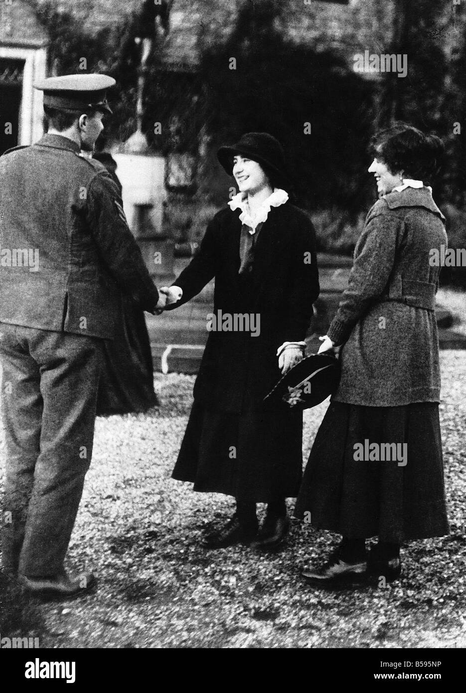 Lady Elizabeth Bowes Lyon Queen Elizabeth the Queen Mother with her sister Lady Rose Leveson Gower shakes hands with one of the Stock Photo