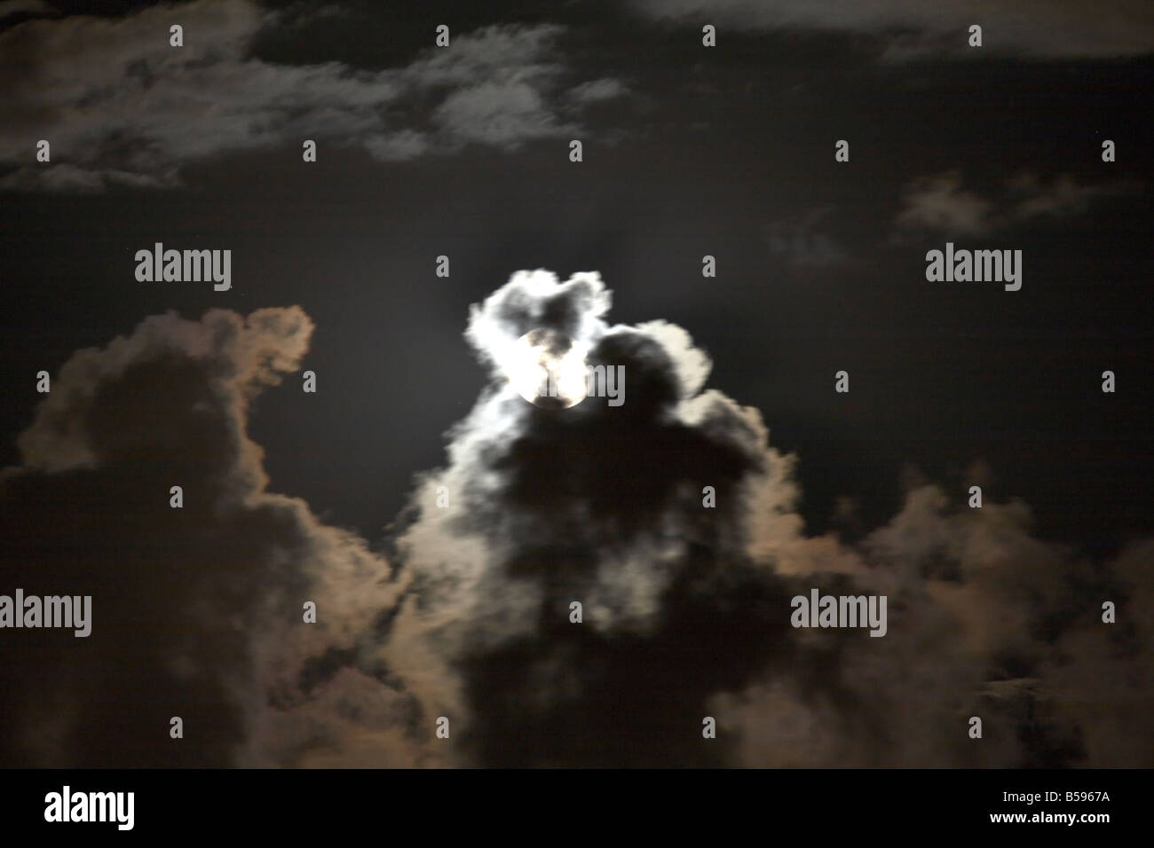 Scudding Full moon behind dark scudding clouds at night in Queensland QLD ...
