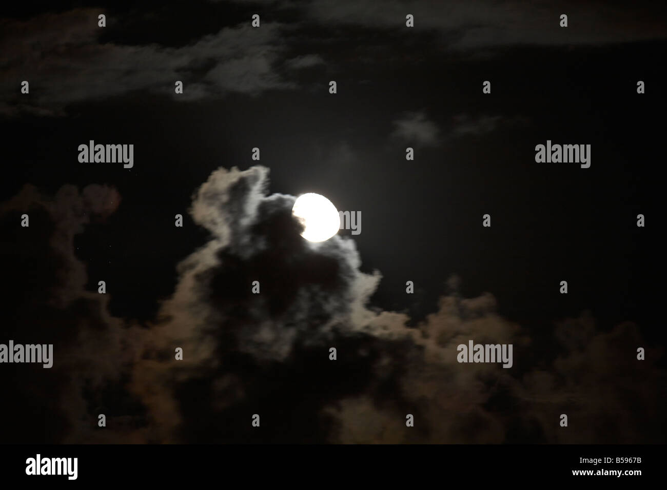 Scudding Full moon behind dark scudding clouds at night in Queensland QLD ...
