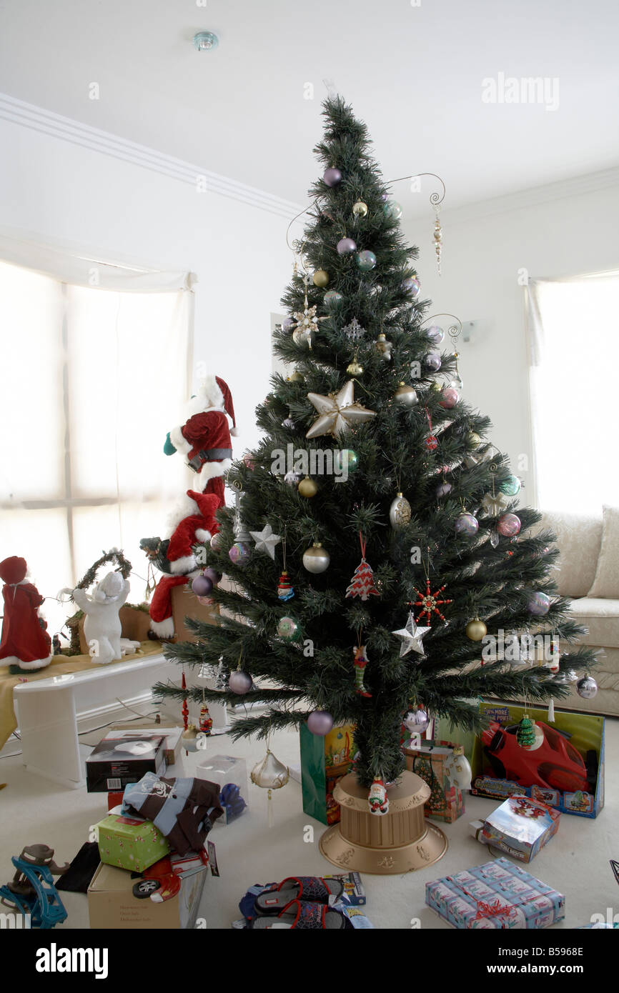 Christmas tree with decorations and presents in daytime living room in