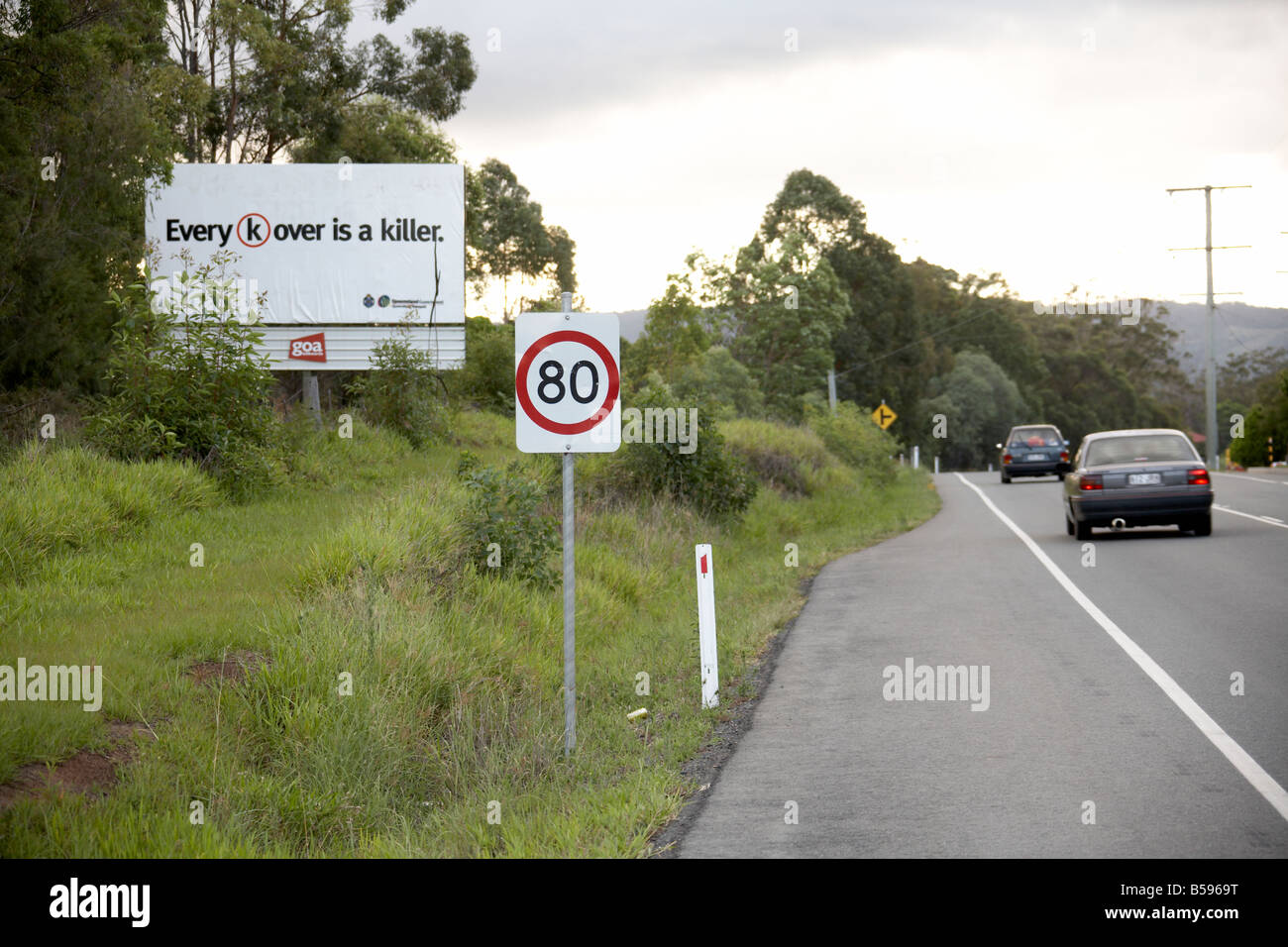 Clever advertising speeding warning notice hoarding poster by a road in Sunshine Coast Queensland QLD Australia KO is Knock Out Stock Photo