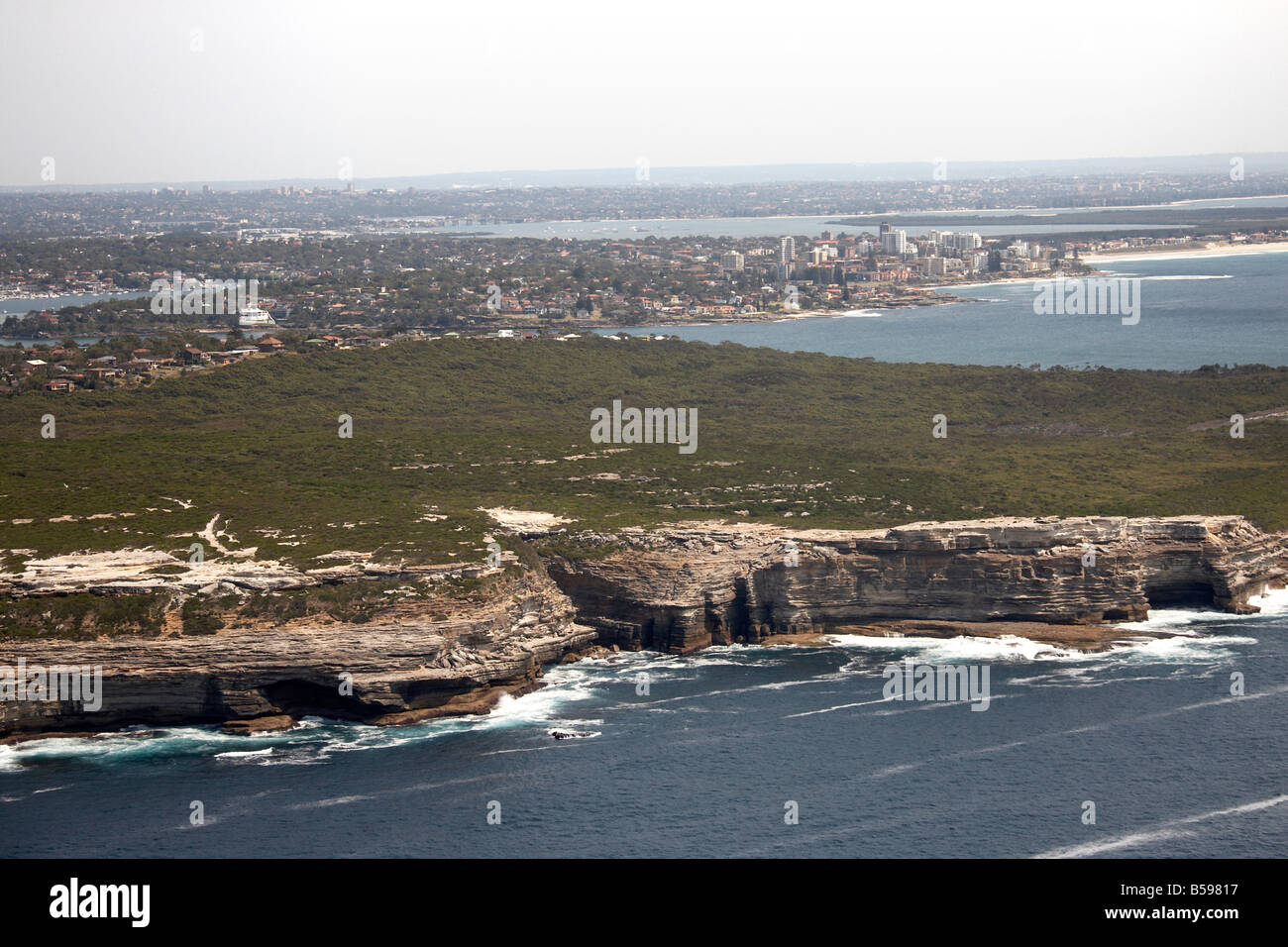 Aerial view north west of Sandstone Rocks Bundeena Bate Bay Tasman Sea Sydney NSW Australia High level oblique Stock Photo