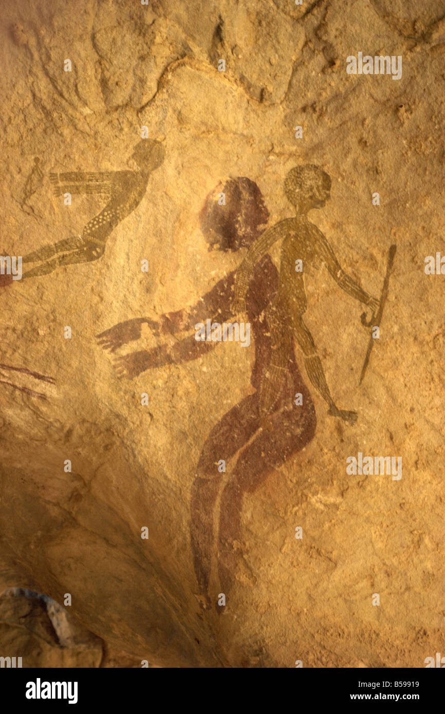 Rock paintings of decorated woman and children on cave Tassili Ajjer Algeria Africa I Griffiths Stock Photo