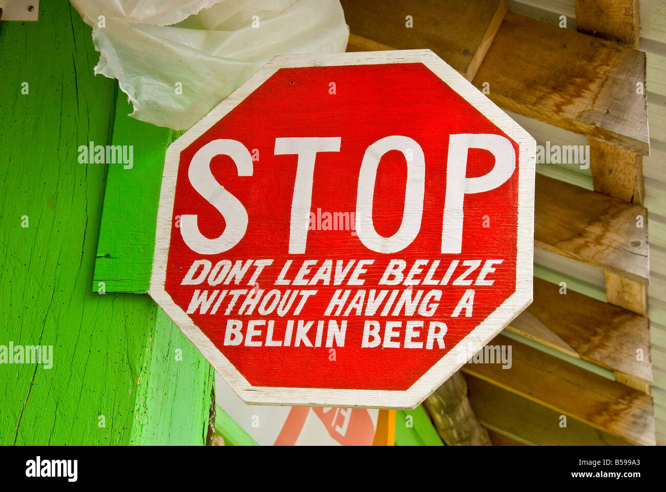 Belize City Belize Tourism Village Stop sign advertising local Belikin beer humor humour Stock Photo