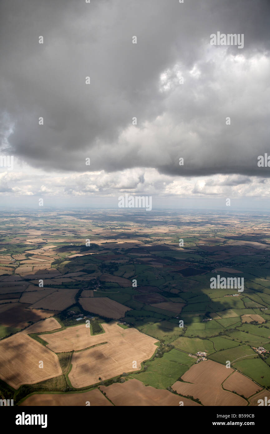 Abstract aerial view south east of country fields grey clouds and cloud shadows Nottinghamshire England UK High level oblique Stock Photo