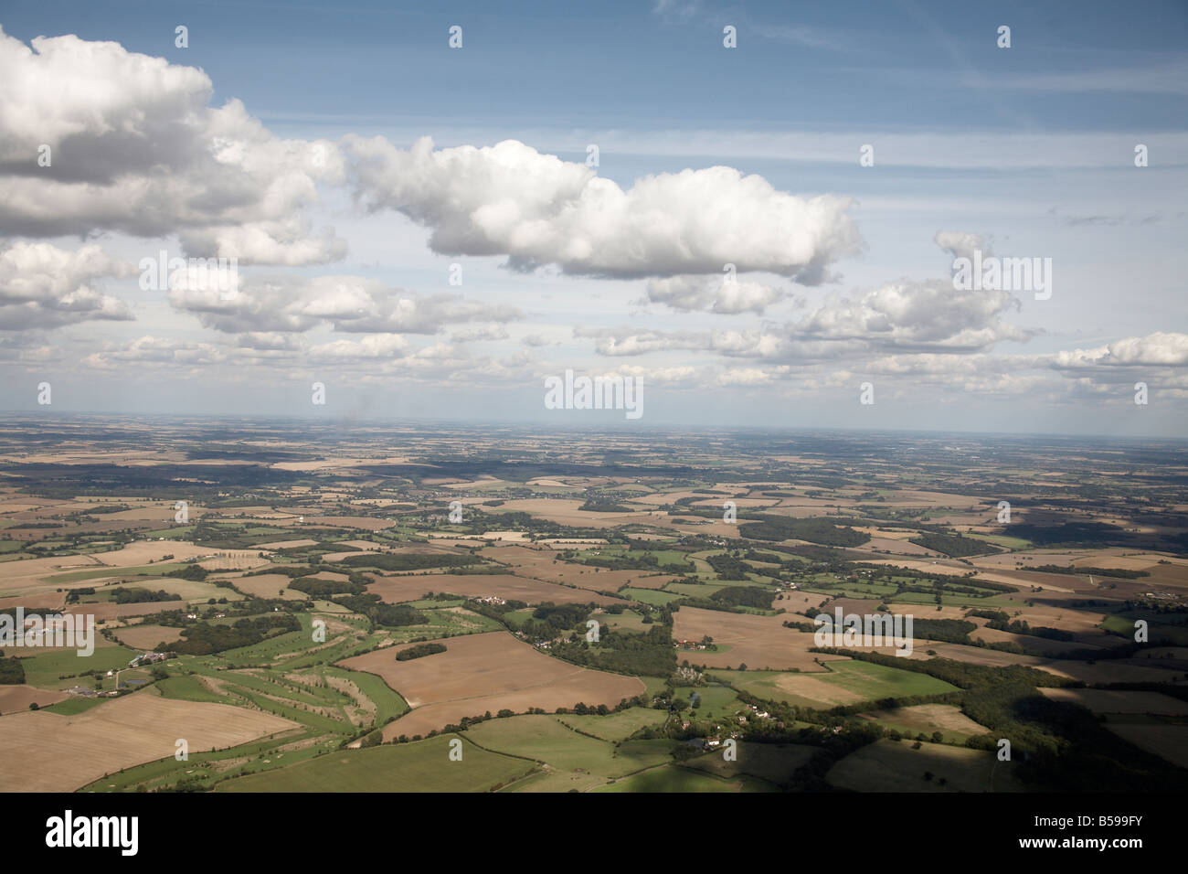 Aerial view north east of country fields forestation and clouds against blue sky Little Munden Herfordshire England UK High leve Stock Photo