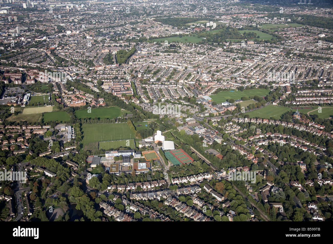 Aerial view north east of Dulwich High School playing fields tennis courts suburban houses Peckham Rye Common London SE22 SE15 Stock Photo