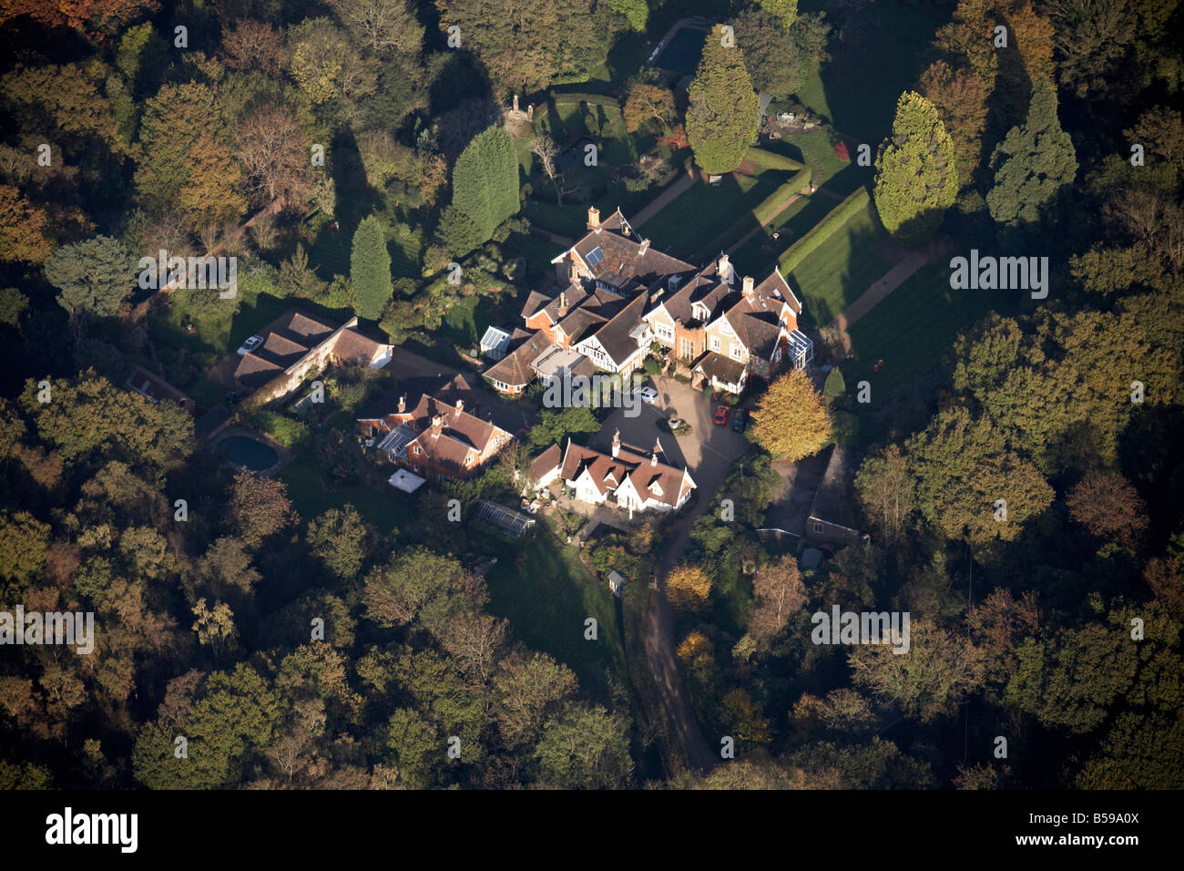 Aerial view east of country houses gardens trees Capel Surrey RH5 England UK Stock Photo