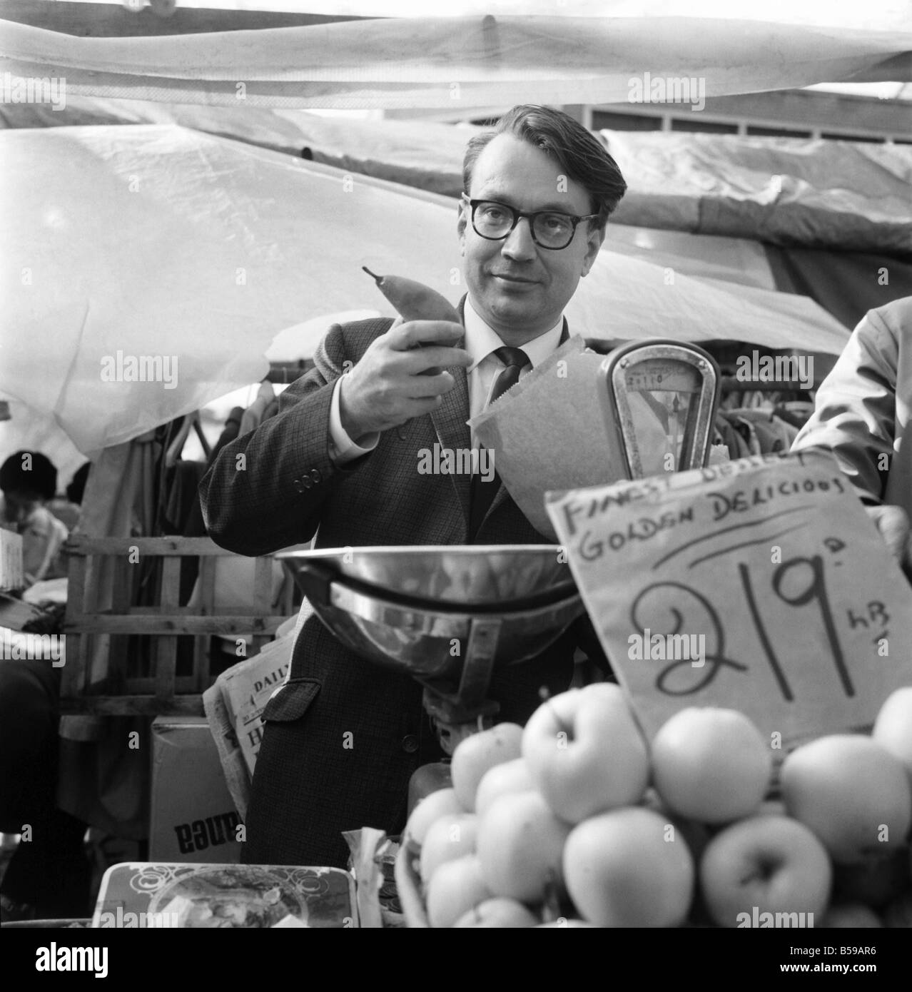Politics: Elections: The Newcastle-under-Lyne by-election: The labour candidate, Golding, is seen talking to stall-holders in the market, serving fruit and portrait (wears glasses). October 1969 Z10368-002 Stock Photo