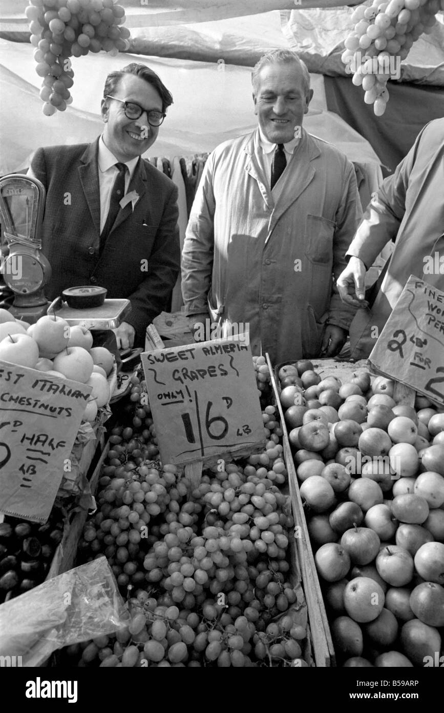Politics: Elections: The Newcastle-under-Lyne by-election: The labour candidate, Golding, is seen talking to stall-holders in the market, serving fruit and portrait (wears glasses). October 1969 Z10368-009 Stock Photo