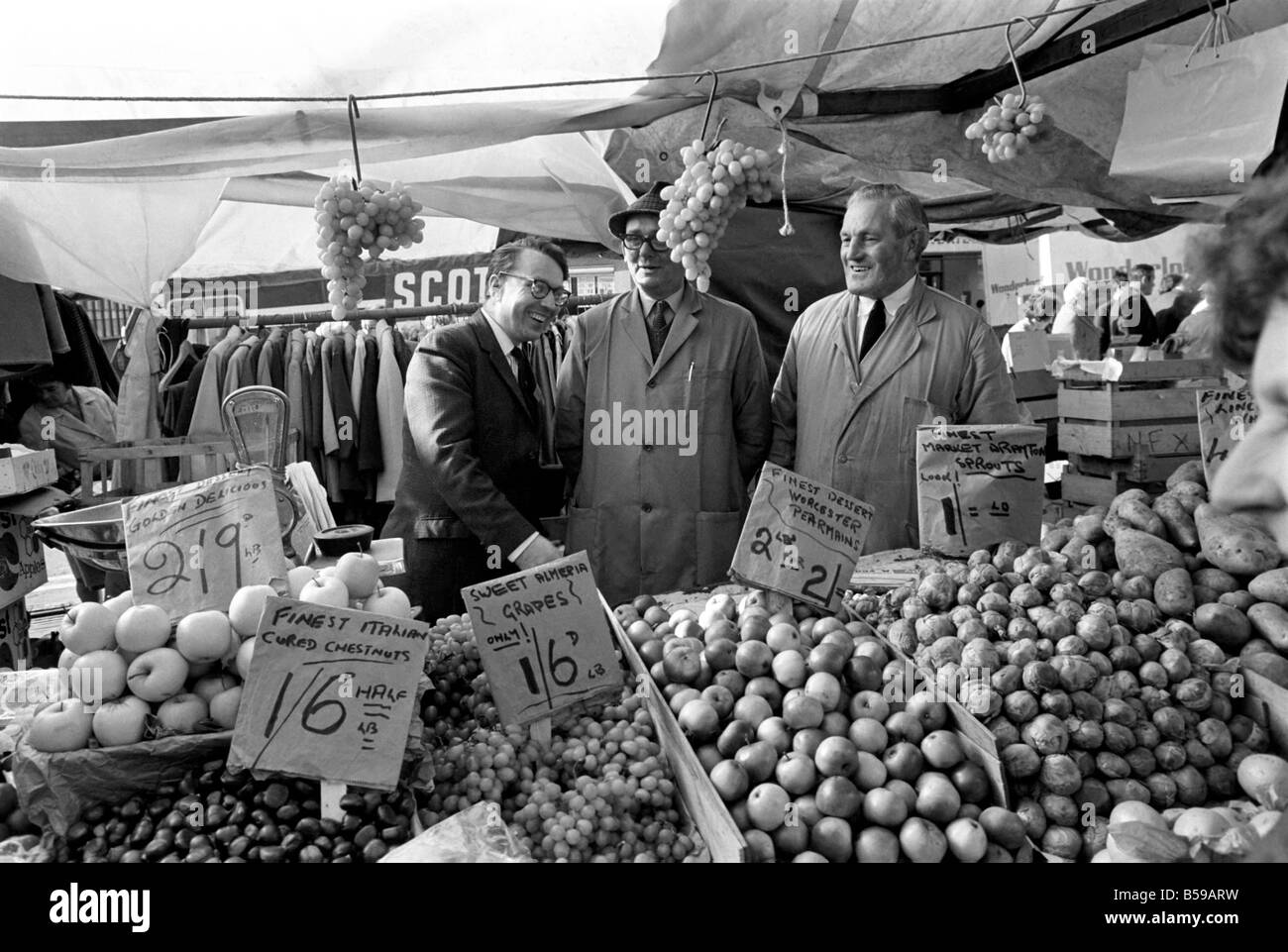 Politics: Elections: The Newcastle-under-Lyne by-election: The labour candidate, Golding, is seen talking to stall-holders in the market, serving fruit and portrait (wears glasses). October 1969 Z10368-010 Stock Photo