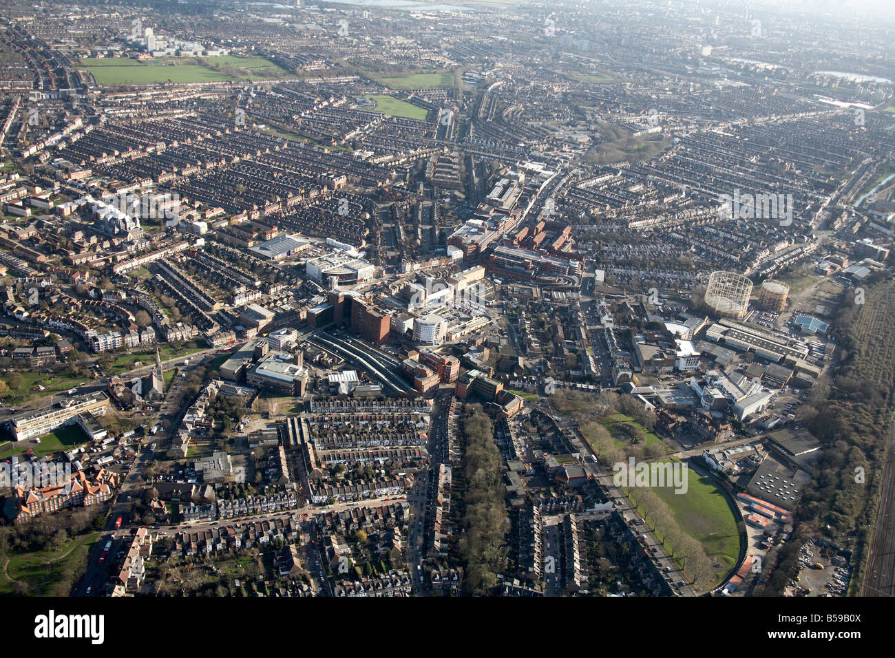 Aerial view south east of Wood Green High Street shopping centre gas works suburban houses playing fields London N22 N8 England Stock Photo