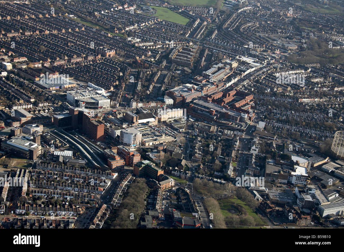 Aerial view south east of Wood Green High Street shopping centre gas works suburban houses playing fields London N22 N8 England Stock Photo