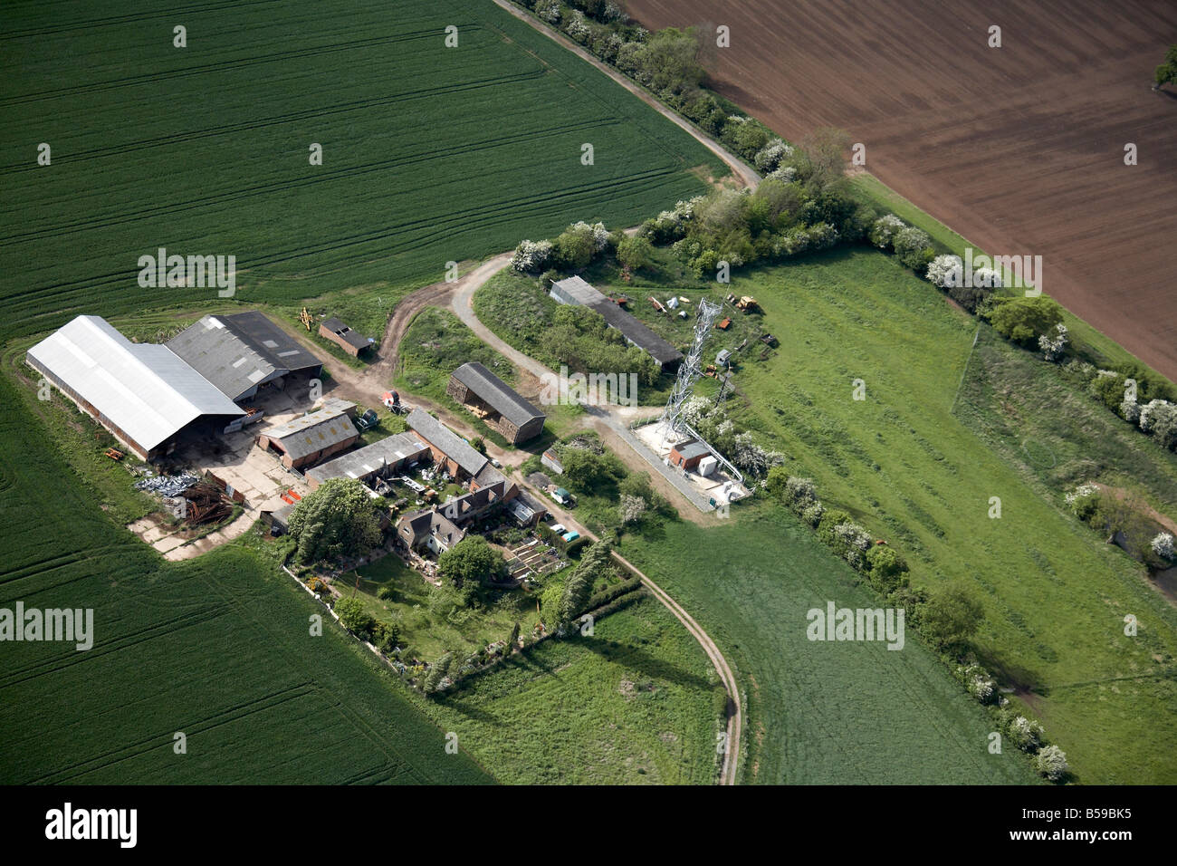 Aerial view north west of country farm fields electricity pylon off Brandon Road Bretford Wolston Warwickshire CV23 England UK Stock Photo