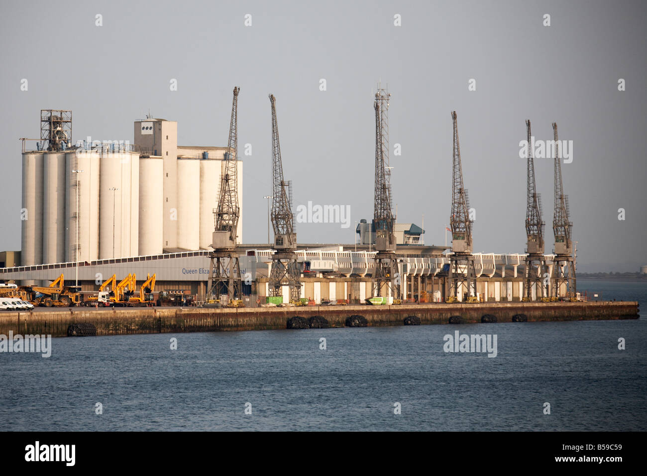 Dock cranes and silos next to sea water near Southampton England UK Stock Photo