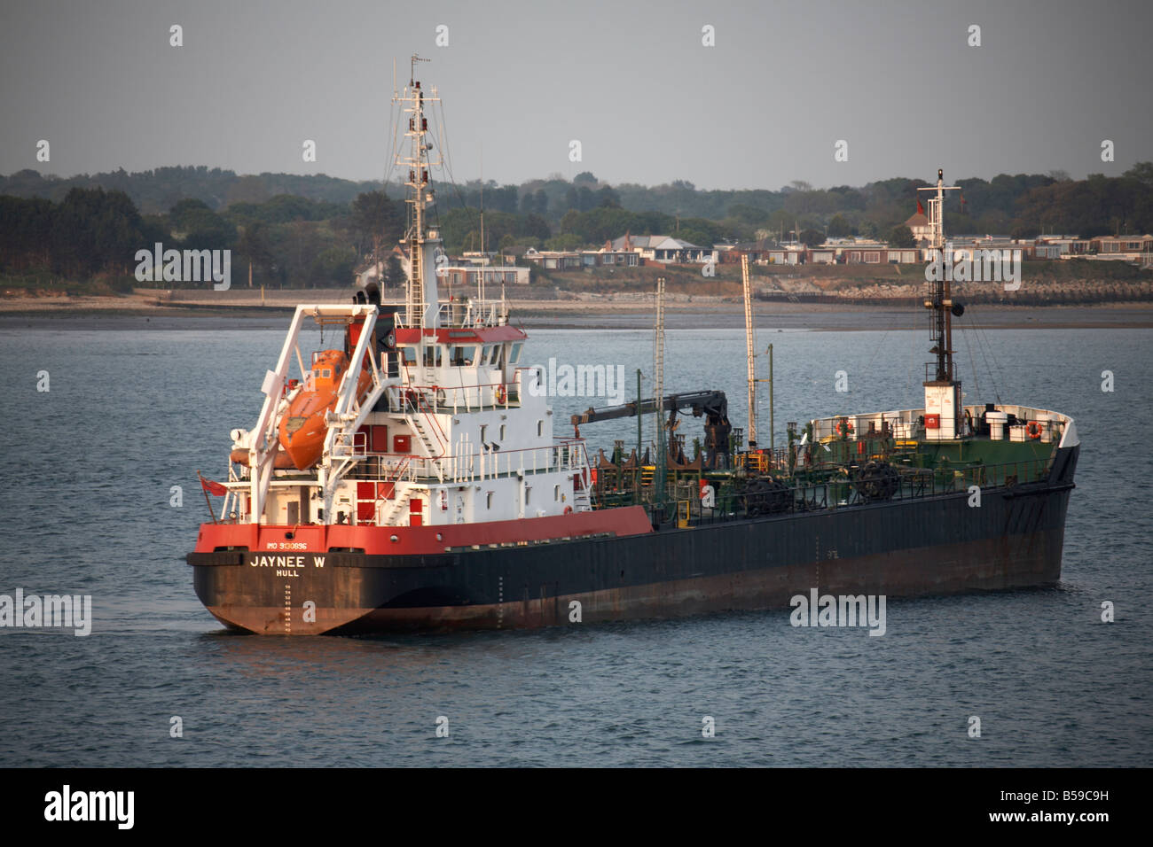 Jaynee merchant shipping vessel ship sailing on Southampton Water in evening light England UK Stock Photo