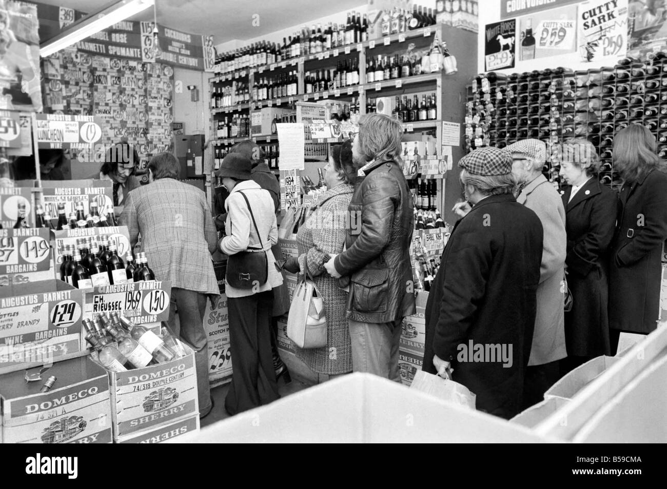 Crowds of people have been trying to beat the budget with the proposed increase in alcohol prices. Our Picture Shows: Shoppers at Augustus Barnett wine shop in Holborn queuing to buy their alcohol. April 1975 75-1911-002 Stock Photo