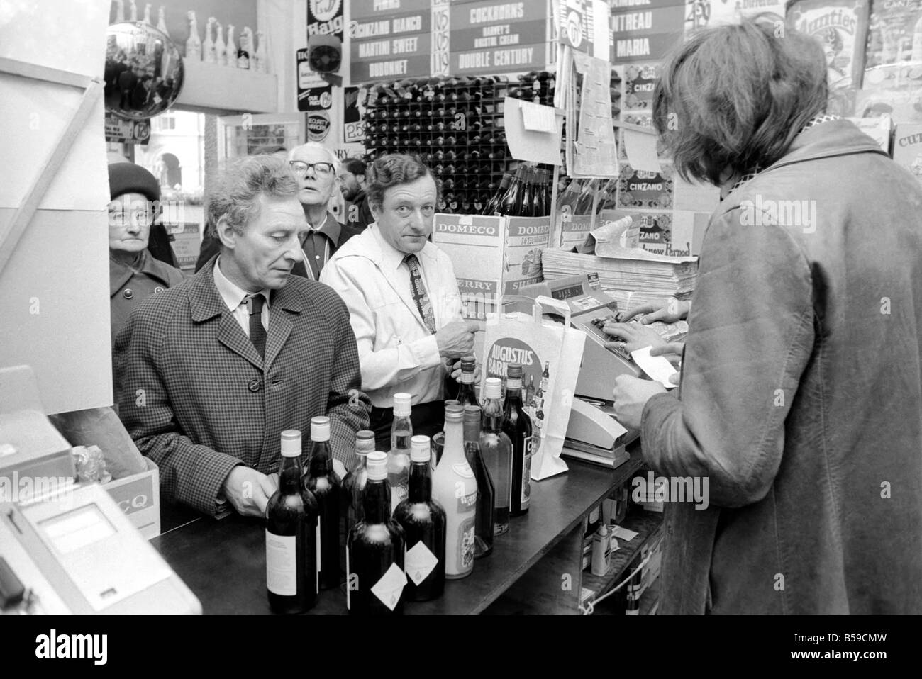 Crowds of people have been trying to beat the budget with the proposed increase in alcohol prices. Our Picture Shows: Shoppers at Augustus Barnett wine shop in Holborn queuing to buy their alcohol. April 1975 75-1911-006 Stock Photo
