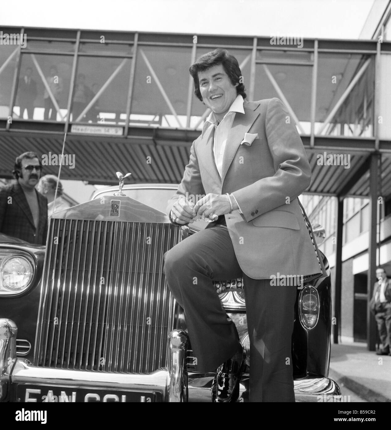 Wayne Newton looking very happy as he leans against a gleaming Rolls