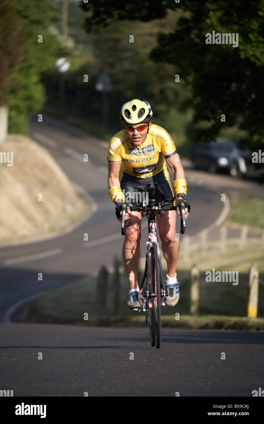Racing tandem cyclists on bicycle road race climbing hill through ...