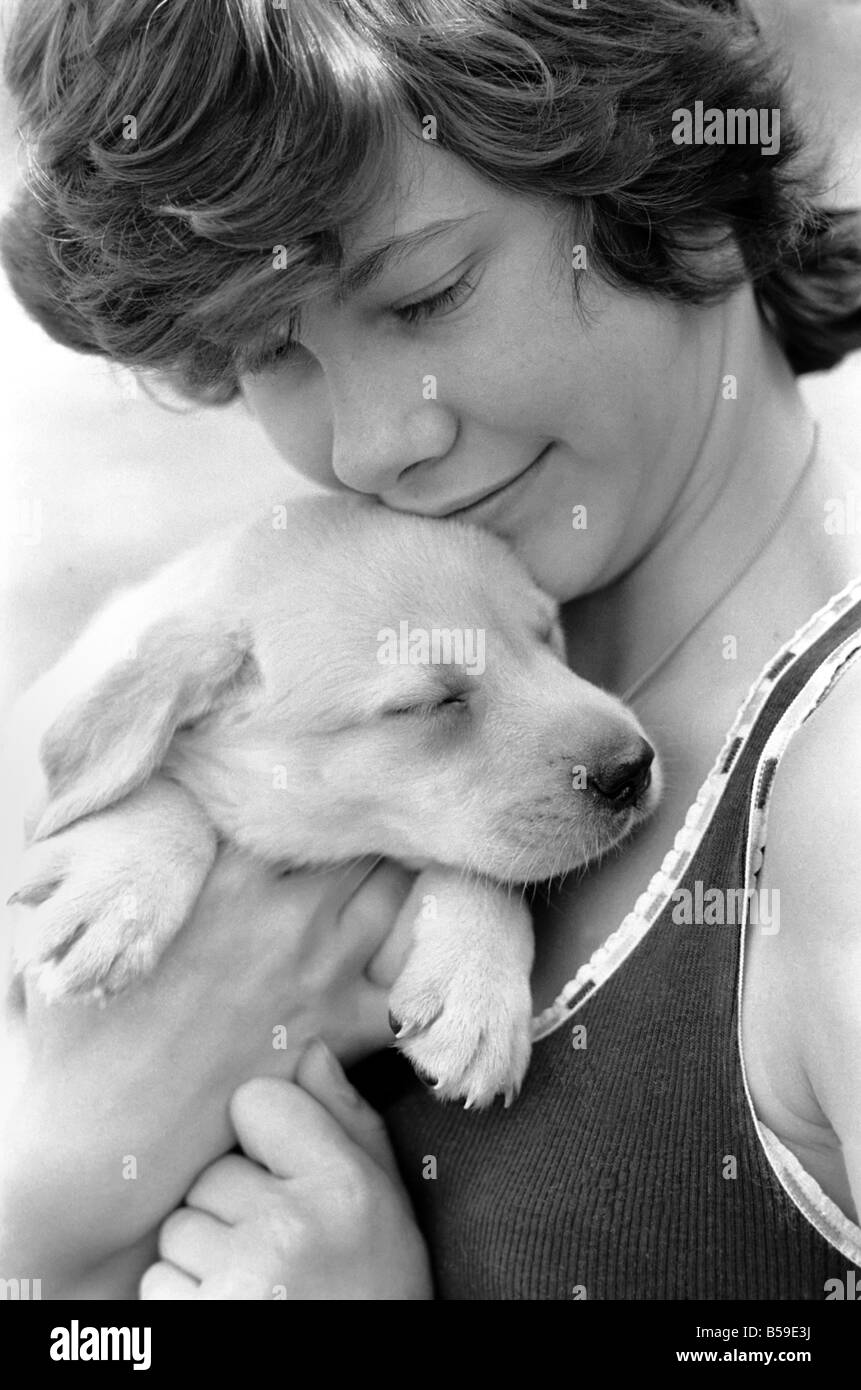 A young girl with a labrador puppy at the Frant Kennels in