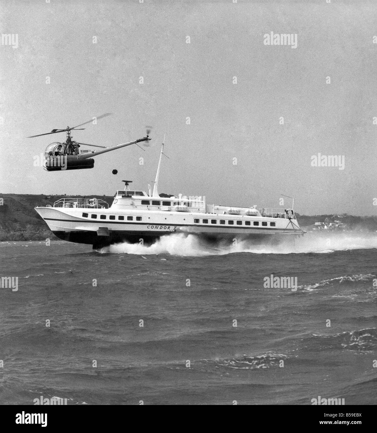 The Hydrofoil Condor 1 at sea of Jersey, overhead is a small helicopter. &#13;&#10;Circa 1969&#13;&#10;P005276 Stock Photo