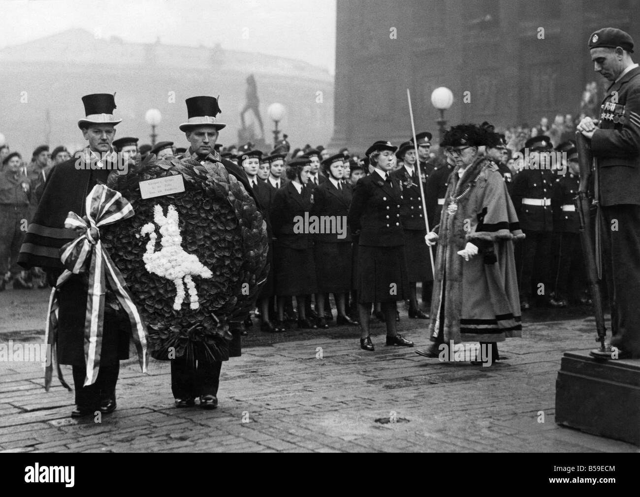 Remembrance service at Liverpool Cenopath: ;The Lord Mayor of Liverpool, Alderman Albert Morrow preceded by his attendants carrying the civic wreath, passes a RAF Sergeant with reversed arms. ;November 1952 ;P005406 Stock Photo
