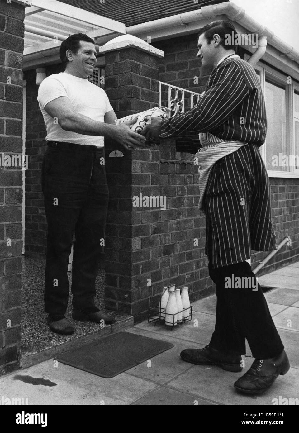 British wrestler Count Bartelli takes in the daily order of meat at his home near Crewe Cheshire. The Condliffe's have a daily order of between four and five pounds of meat most of which is eaten by 'The Count'. Butcher is Stuart Taylor. ;April 1971 ;P005668 Stock Photo