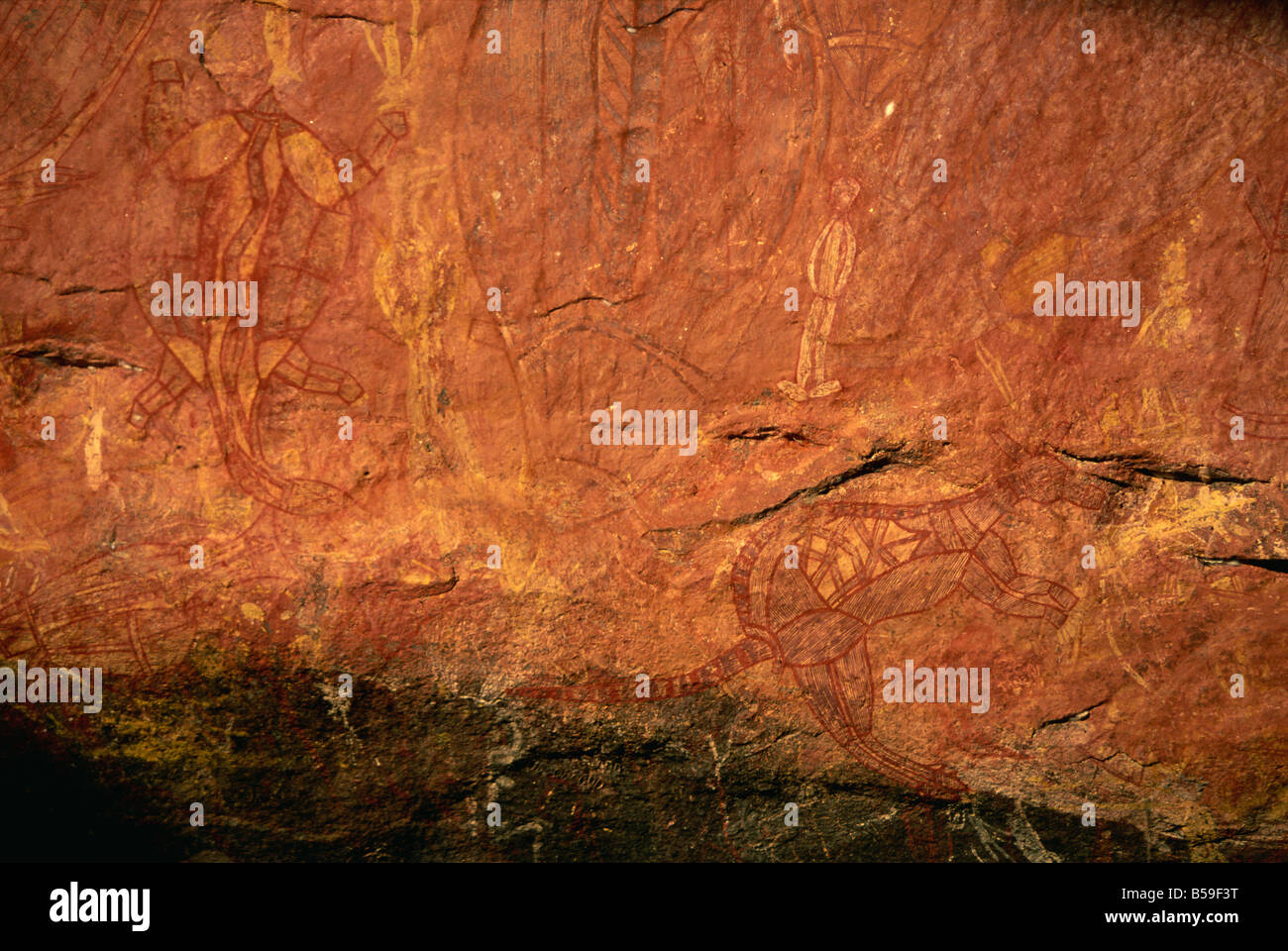 X-ray style fish, turtle, wallaby and white man at the Aboriginal rock art site at Ubirr Rock, Kakadu National Park, Australia Stock Photo