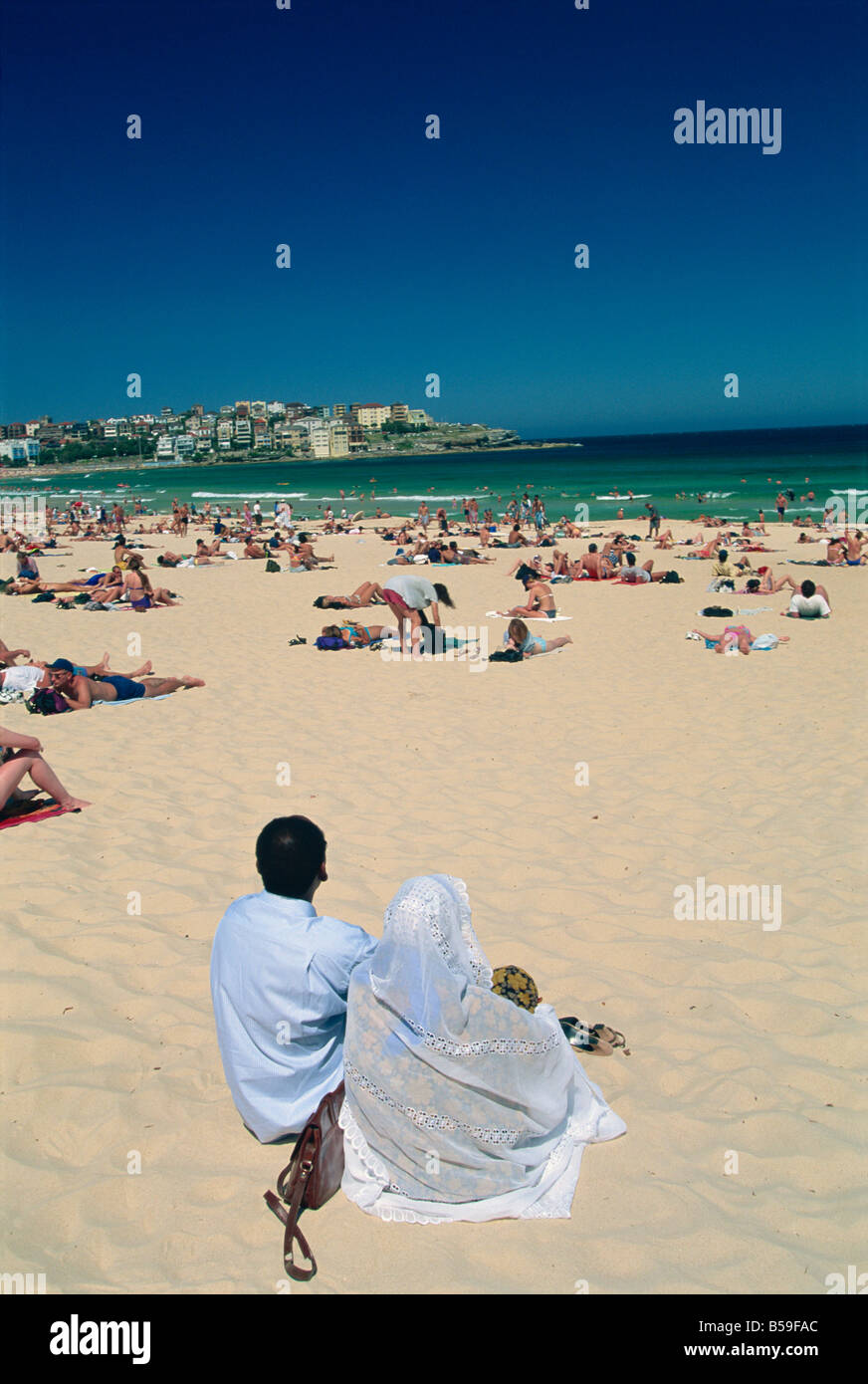 Muslim couple fully clothed on Bondi Beach, Bondi, Sydney, New South Wales, Australia, Pacific Stock Photo