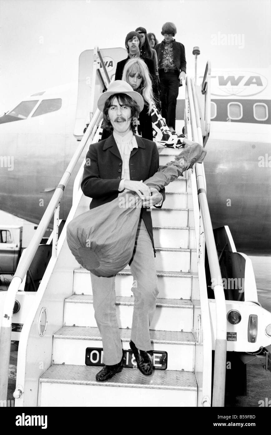 Beatles guitarist Harrison complete with sitar at Heathrow. June
