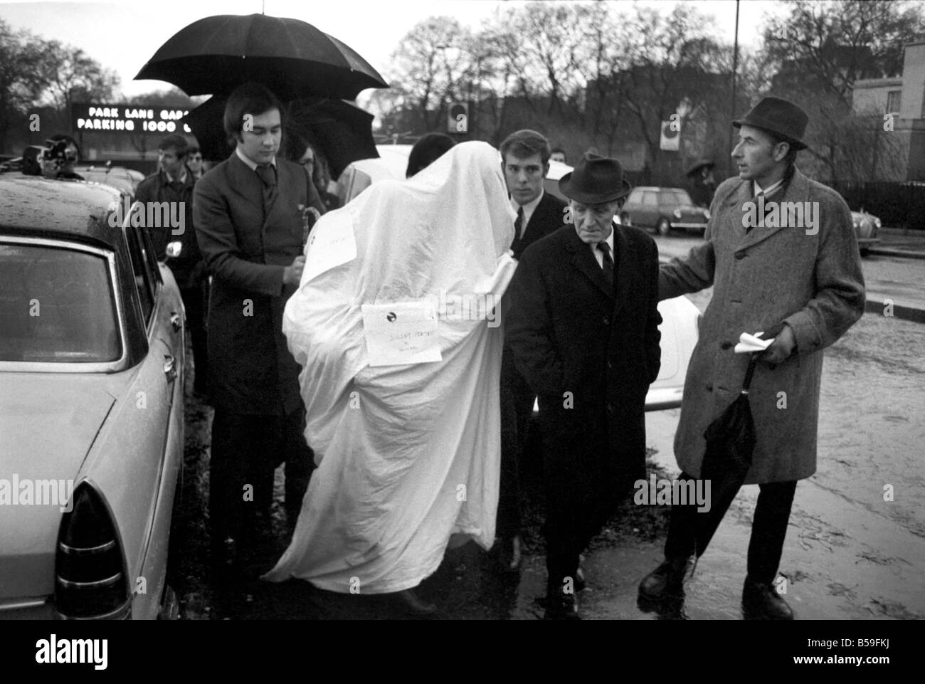 John Lennon and wife Yoko Ono under their sheet with Mr. James Hanratty on the extreme right, at Speakers Corner during a protest against the execution of James Hanratty, for the A6 murders;December 1969 ;Z12069-001 Stock Photo