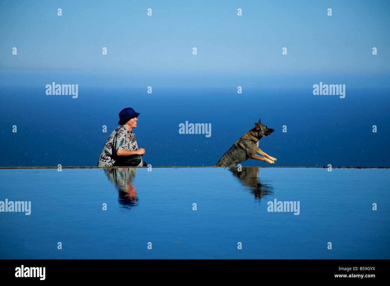 Girl playing with dog at Meditation pond (Hill 3 Blues), Stanwell Park, New South Wales, Australia, Pacific Stock Photo