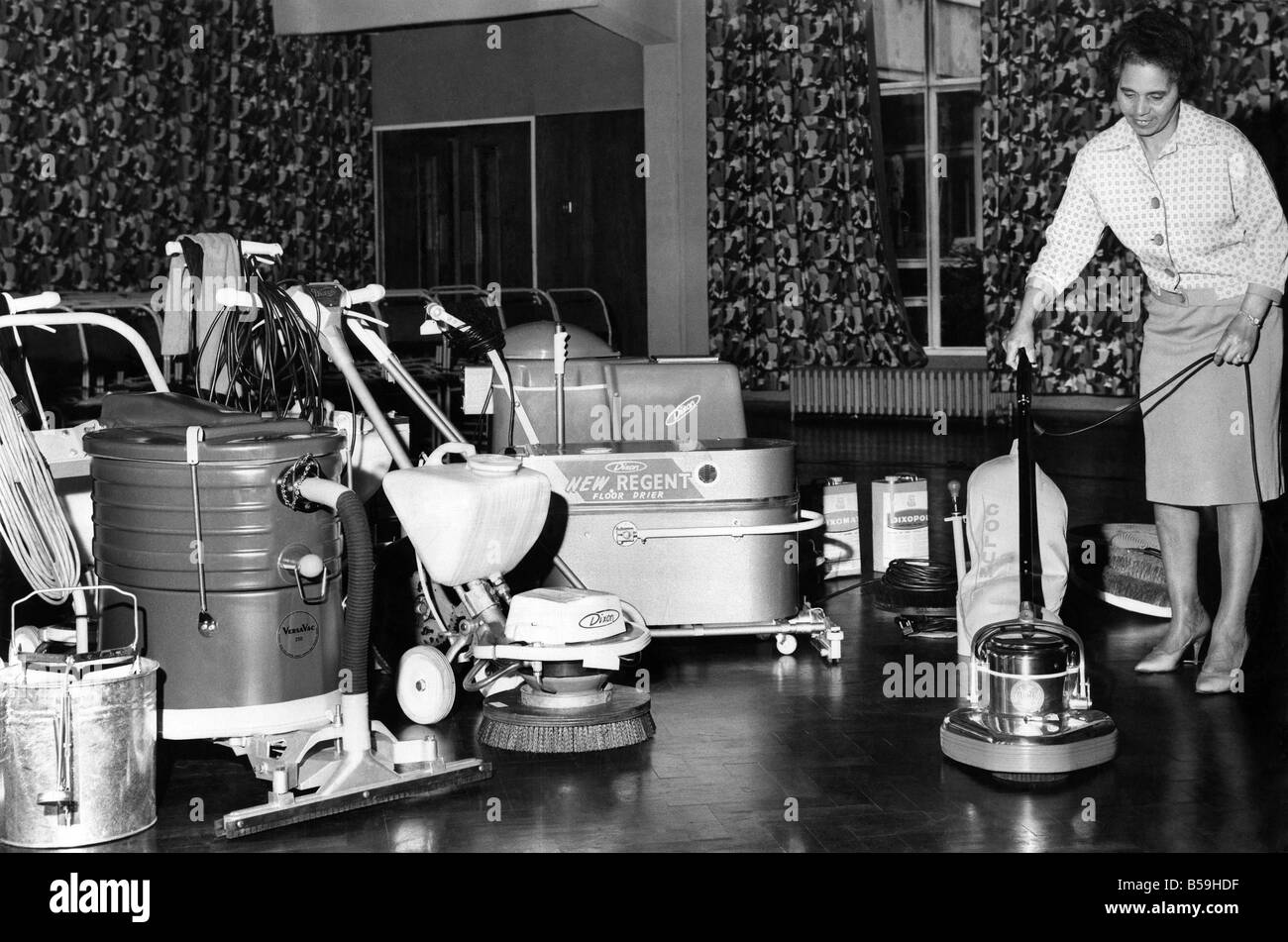 School charwoman Mrs Mabel McKennas gets her first glimpse of the automatic school cleaning equipment at Salford, Manchester.;July 1966 ;P005210 Stock Photo