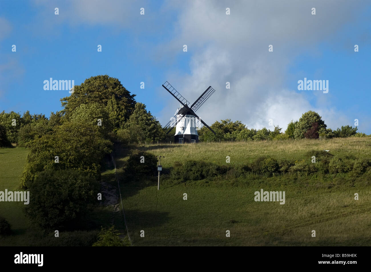 A windmill on the top of a chiltern Hill on a sunny day with blue sky Stock Photo